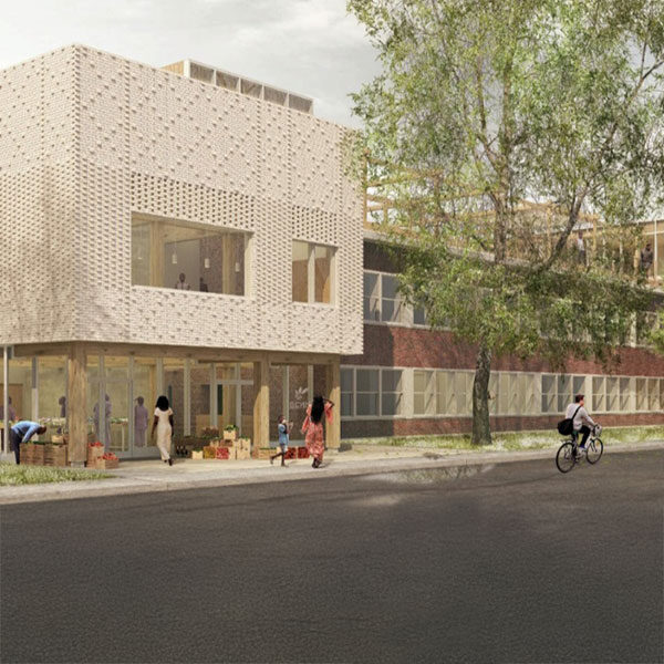 EN: A newly constructed, two-storey modern building with geometric patterns and large windows. FR: Un bâtiment moderne de deux étages récemment construit avec des motifs géométriques et de grandes fenêtres.